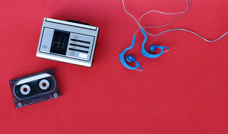 A cassette player, a cassette and earphones from the 90s for listening to music on the goの写真素材