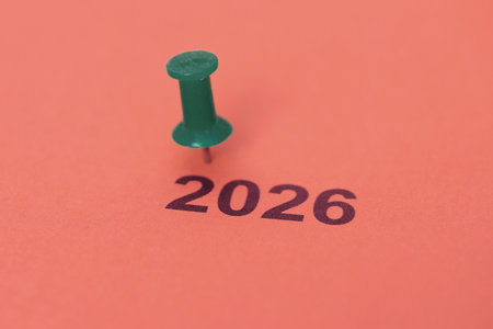 A thumbtack and a sheet of paper with the year 2026 written on itの写真素材