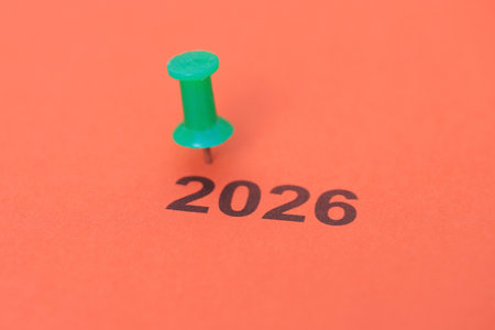 A thumbtack and a sheet of paper with the year 2026 written on itの写真素材