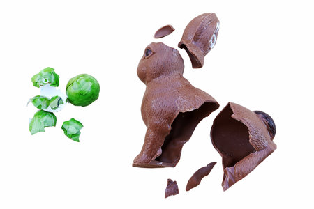 When Easter is over. A broken Easter egg and a chocolate bunny isolated on a white backgroundの写真素材