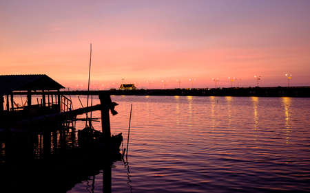 purple twilight in evening at port near river and bridgeの写真素材