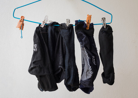 dirty socks on  clothes hanger by man who hurry
