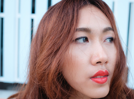close up on eyes and face asian beauty hair,Portrait of tender natural beautiful redhead young adult woman looking camera at homeの写真素材