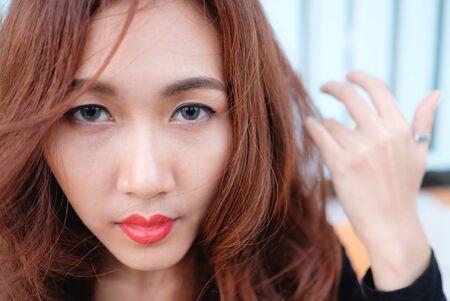 close up on eyes and face asian beauty hair,Portrait of tender natural beautiful redhead young adult woman looking camera at homeの写真素材