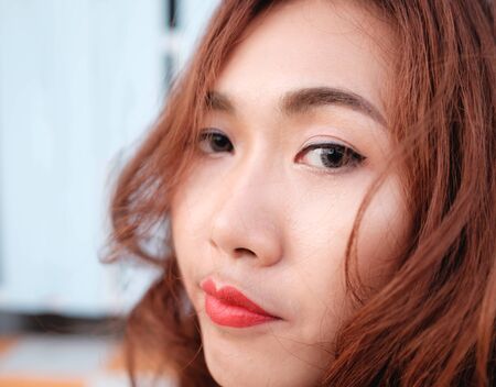 close up on eyes and face asian beauty hair,Portrait of tender natural beautiful redhead young adult woman looking camera at homeの写真素材