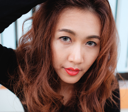 close up on eyes and face asian beauty hair,Portrait of tender natural beautiful redhead young adult woman looking camera at homeの写真素材