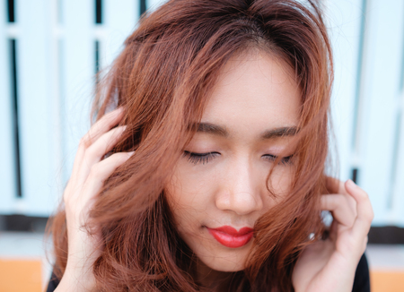 close up on eyes and face asian beauty hair,Portrait of tender natural beautiful redhead young adult woman looking camera at homeの写真素材