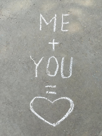 chalk inscription on the asphalt me plus you is love. heart, message, recognition, summer, wedding, valentine, card, poster stickerの写真素材