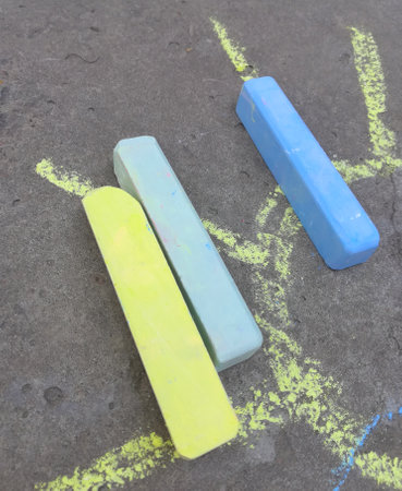 sun is drawn with chalk on the asphalt. fun summer game. children drawing.の写真素材