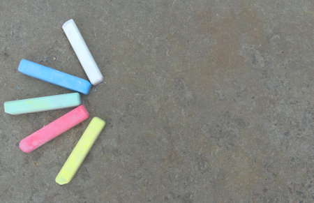 multi-colored crayons lie on the asphalt. fun summer game. children drawing, creativity. banner,...