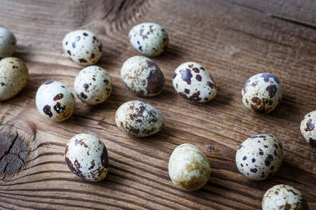 Sprinkled quail eggs on a wooden table. Food and cooking.の写真素材