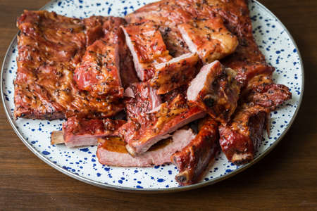 Smoked pork ribs on a decorative plate -sliced pieces. Food and cooking.の写真素材