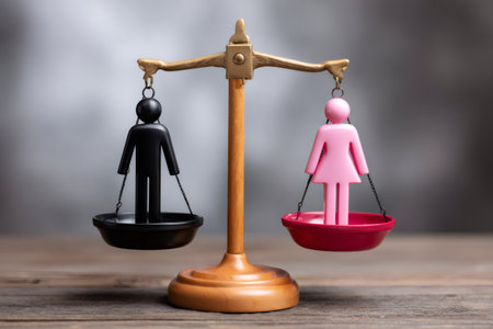 Scales balancing male and female figurines conceptualizing gender equality and human rightsの素材