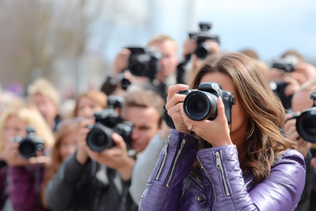 Paparazzi and photographers capturing an event outside with camerasの素材