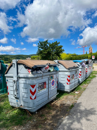 SARTEANO, ITALY - 05.08.2023: Dumpsters on the same site. Separate collection of garbage by different categories.のeditorial素材