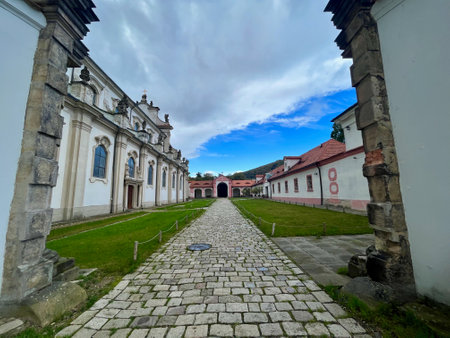 Cistercian state monastery Osek, Ossegg front church, Czech Republic. A rose hip bushの写真素材