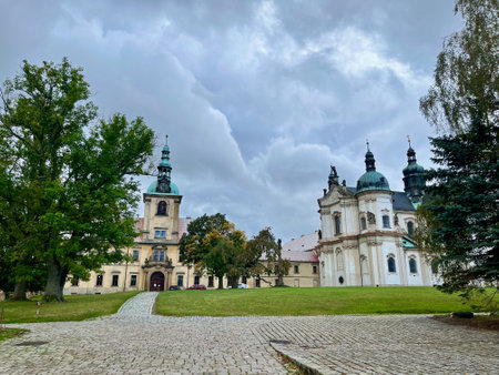 Cistercian state monastery Osek, Ossegg front church, Czech Republic. A rose hip bushの写真素材