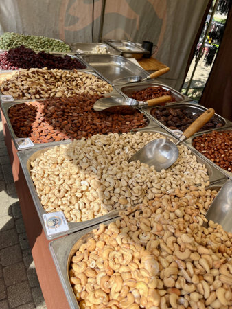 Hazelnuts, dates, walnuts, raisins, dried fruits and other food on market table.