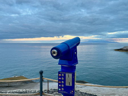 Spyglass on the seashore. Panorama of binoculars and North Atlantic ocean in the background. Spain
