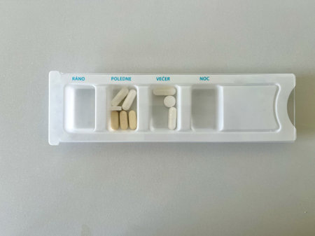 The pills are arranged in a pillbox, by time of day. Inscriptions morning, noon, evening, night
