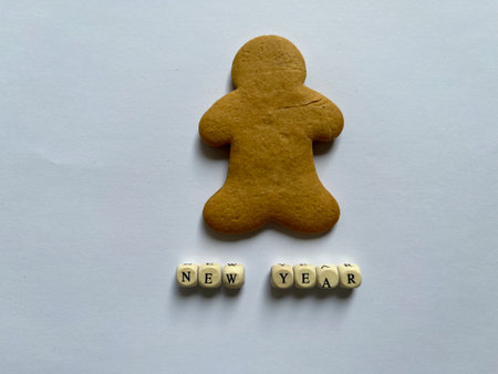 Gingerbread snowman cookie and Merry Christmas in 3d alphabet letters isolated on a white background