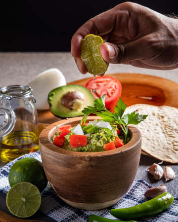 Typical entremes of Mexican cuisine, made with avocado, onion, tomato, lemon, coriander and sometimes spicyの写真素材