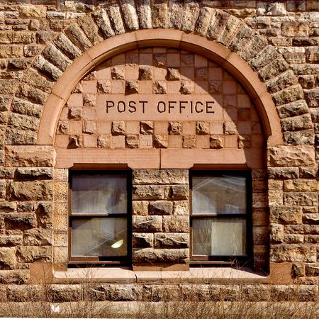 Post Office written atop on old style window.の写真素材