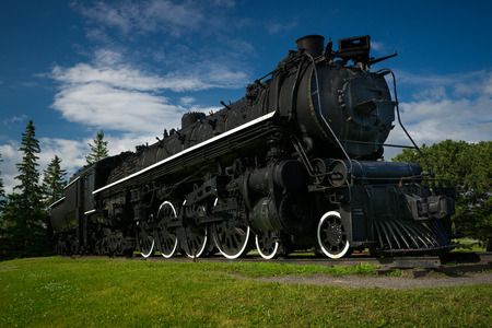 A large, black antique steam train