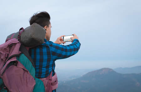 young man with backpack in the mountain