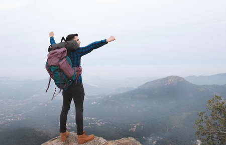 young man with backpack in the mountain