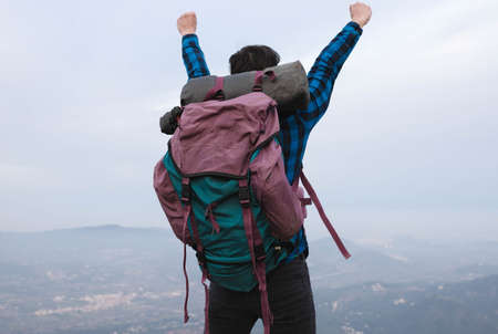 young man with backpack in the mountain