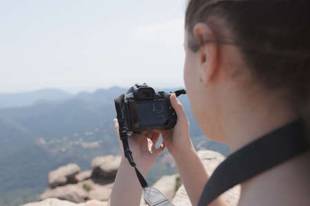 girl with camera on the mountain
