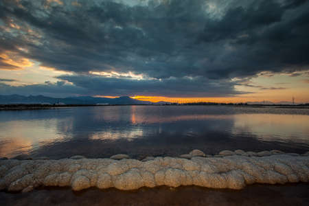 Deposit of salt under cloudy skyの写真素材
