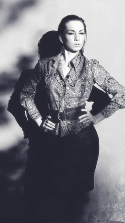 beautiful woman standing near the wallの写真素材