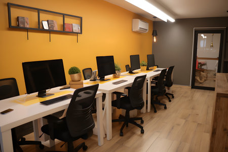 Interior of a modern office with yellow walls and wooden floor.の素材