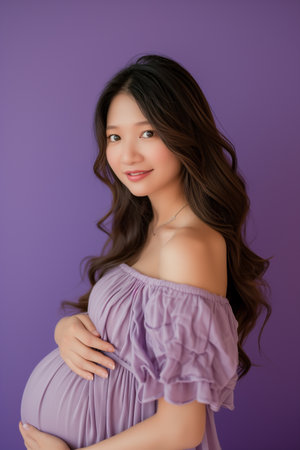 Portrait of a beautiful Asian pregnant woman on purple background.の素材