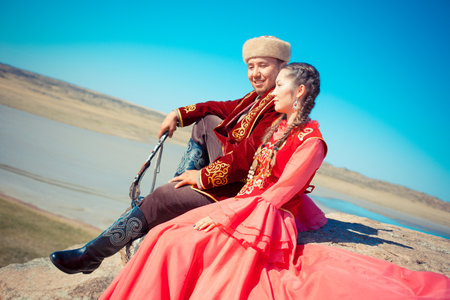 Young couple in traditional clothing on the beach.の写真素材