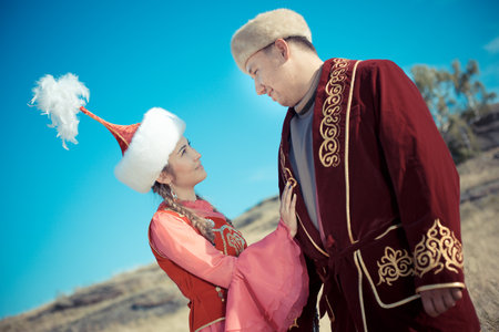 A man and a woman in the traditional costume of the Middle Ages.Kazakh woman and man in national...