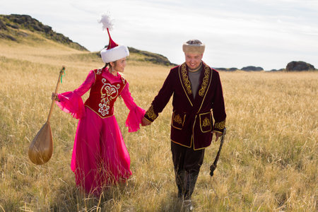 Kazakh woman and man in national costumesの写真素材
