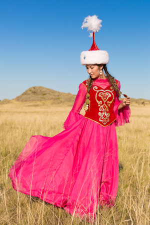 Kazakh woman and man in national costumesの写真素材