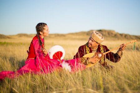 Kazakh woman and man in national costumesの写真素材