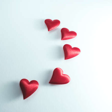 lots of little red hearts flying on white background. romantic love background for Valentine's day,...