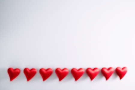 lots of little red hearts flying on white background. romantic love background for Valentine's day, birthday, holiday, party, wedding. Blurred imageの写真素材