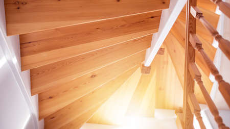 Wooden staircase in a white modern house  on a sunny dayの写真素材