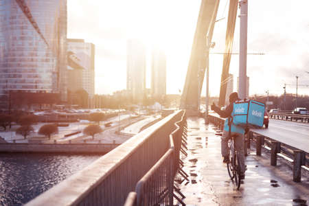 Latvia, Riga, March 05, 2021: Wolt food delivery. Bicycle courier.のeditorial素材
