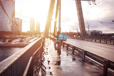 Latvia, Riga, March 05, 2021: Wolt food delivery. Bicycle courier.のeditorial素材