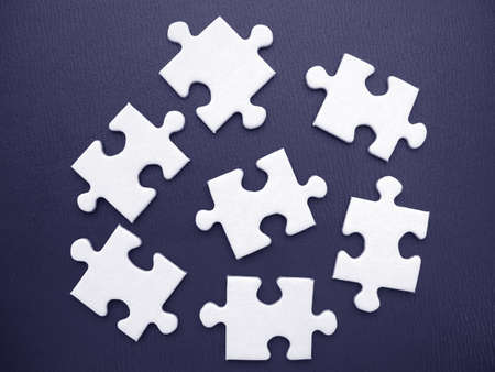 White jigsaw on a blue backgroundの写真素材