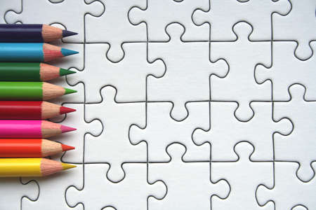 Colorful pencils on jigsaw backgroundの写真素材