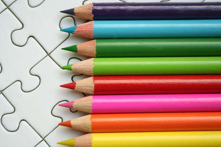 Colorful pencils on jigsaw backgroundの写真素材