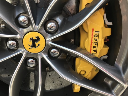 Marbella, Spain - August 10, 2018: Part of a red Ferrari parked inside the famous Puerto Banus. Luxury port where you can take a walk, have a drink and see large and luxurious yachtsのeditorial素材